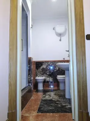 a bathroom with two sinks and two toilets at Apartment in a 1400s building in Via dei Coronari Piazza Navona in Rome
