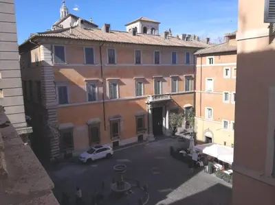 a building with a car parked in a parking lot at Apartment in a 1400s building in Via dei Coronari Piazza Navona in Rome