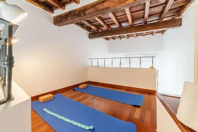 a yoga room with blue mats on the floor at HospitalityRome Piazza di Spagna View in Rome