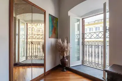 a hallway with a large mirror and a balcony at HospitalityRome Piazza di Spagna View in Rome