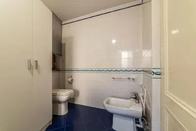 a white bathroom with a toilet and a sink at HospitalityRome Piazza di Spagna View in Rome