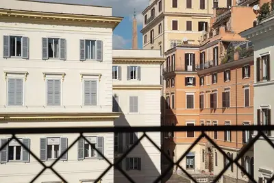 a view from behind a fence of buildings at HospitalityRome Piazza di Spagna View in Rome