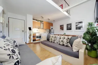 a living room with a couch and a kitchen at Design accommodation in Rome