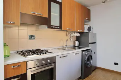 a kitchen with a sink and a stove top oven at Design accommodation in Rome