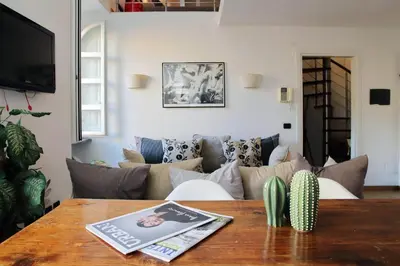 a living room with a couch and a table at Design accommodation in Rome