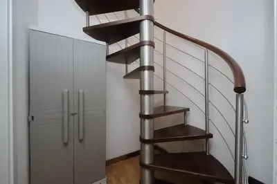 a metal spiral staircase next to a locker at Design accommodation in Rome