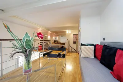 a living room with a vase of flowers on a table at Design accommodation in Rome