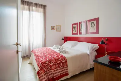 a bedroom with a bed with a red headboard at RELAIS DEI GOTI in Rome