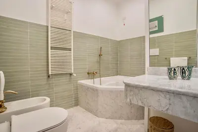 a bathroom with a tub and a toilet and a sink at RELAIS DEI GOTI in Rome