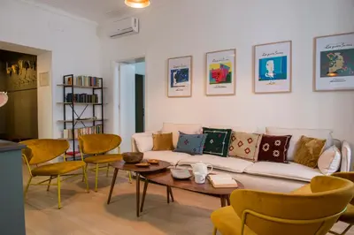 a living room with a couch and a table and chairs at RELAIS DEI GOTI in Rome