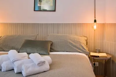 a bedroom with two towels on a bed at RELAIS DEI GOTI in Rome