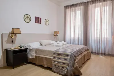 a bedroom with a bed with two stuffed animals on it at RELAIS DEI GOTI in Rome
