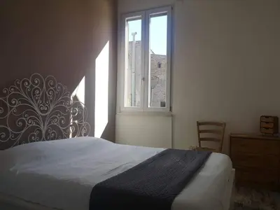 a bedroom with a bed and a window at Soulmate Rooftop Apartment in Rome