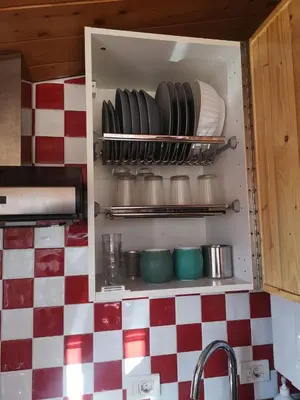 a cabinet with plates and pans in a kitchen at Soulmate Rooftop Apartment in Rome