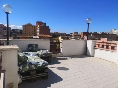 a balcony with two beds on a roof at Soulmate Rooftop Apartment in Rome