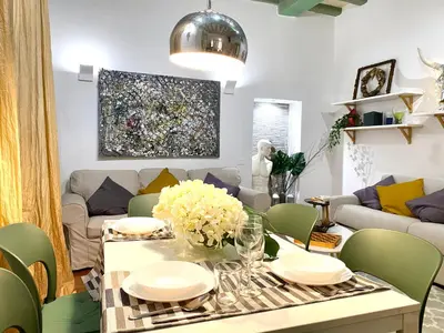 a living room with a table and a couch at Pantheon Ancient Rome Apartment in Rome