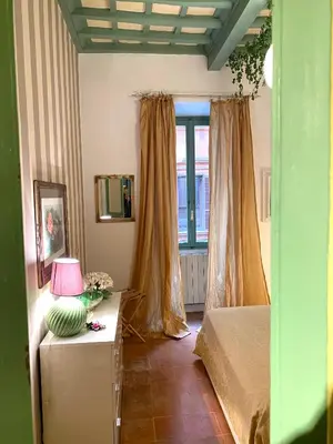 a bedroom with a bed and a table with a lamp at Pantheon Ancient Rome Apartment in Rome