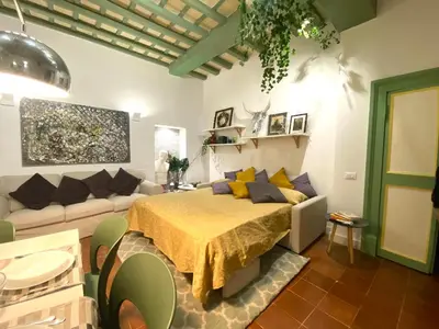 a living room with a bed and a couch at Pantheon Ancient Rome Apartment in Rome