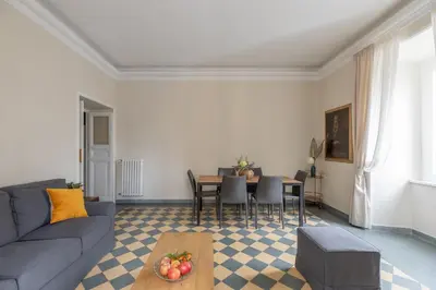 a living room with a couch and a table at iFlat Vatican Elegant Apartment in Rome