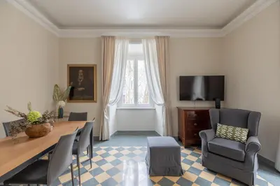 a living room with a table and chairs and a television at iFlat Vatican Elegant Apartment in Rome