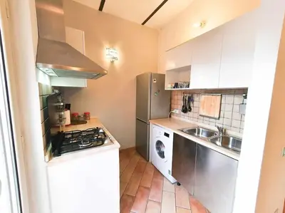a small kitchen with a stove and a sink at Cozy Apartment in Pigneto up to 4 in Rome