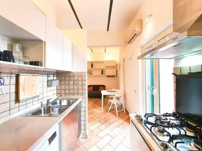 a kitchen with a sink and a stove top oven at Cozy Apartment in Pigneto up to 4 in Rome