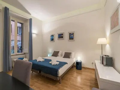 a bedroom with a bed with two towels on it at The Best Rent - Elegant flat near Colosseum in Rome