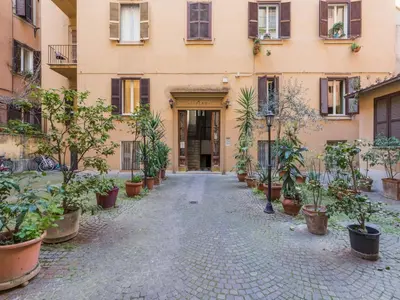 an alley in front of a building with potted plants at The Best Rent - Elegant flat near Colosseum in Rome