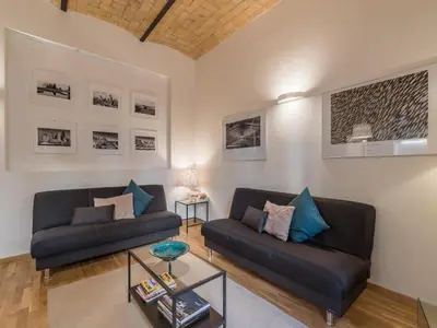 a living room with two couches and a table at The Best Rent - Elegant flat near Colosseum in Rome