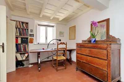 an office with a desk and a dresser in a room at Bright Penthouse Downtown in Rome