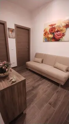 a living room with a couch and a table at Appartamento Fiore Roma San Pietro in Rome