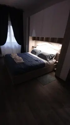 a bedroom with a bed with blue sheets and a window at Appartamento Fiore Roma San Pietro in Rome