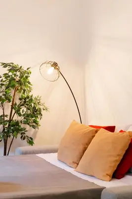 a lamp sitting next to a bed with pillows at Campo de' Fiori appartamento via di Grotta Pinta in Rome