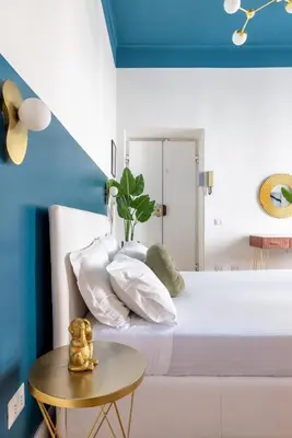 a bedroom with a white bed with a blue ceiling at LABICANA Apt - Colosseum in Rome