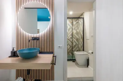 a bathroom with a blue sink and a mirror at LABICANA Apt - Colosseum in Rome