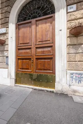 a large wooden door on the side of a building at LABICANA Apt - Colosseum in Rome