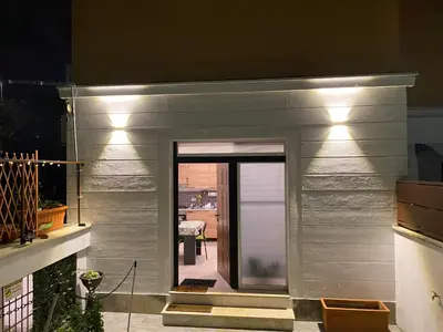 a door to a house with lights on it at OFFICINALE Rome Apartment, Pineta Sacchetti in Rome