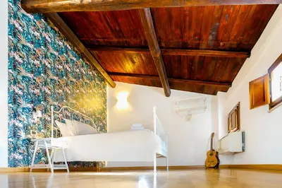 a room with a white bench in front of a colorful wall at Magikrooms Muse in Rome