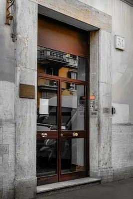 a glass door to a building with a sign in it at Magikrooms Muse in Rome