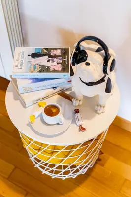 a table with a cup of coffee and a book and headphones at Magikrooms Muse in Rome