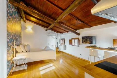 a living room with white walls and wooden ceilings at Magikrooms Muse in Rome