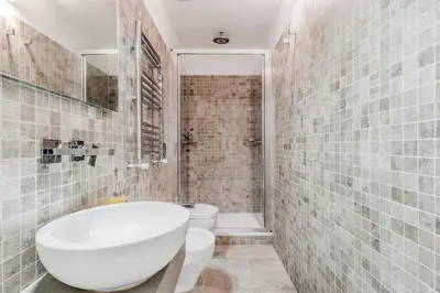 a bathroom with a white tub and a toilet at TH Trastevere Luxury-S.Cosimato 2bd-2bt in Rome