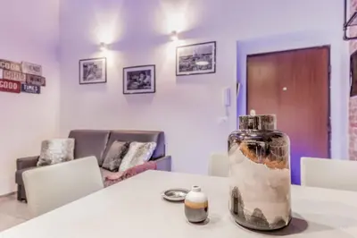 a bottle sitting on a table in a room at TH Trastevere Luxury-S.Cosimato 2bd-2bt in Rome
