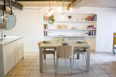 a kitchen and dining room with a table and chairs at Ottavia al Foro - Luxury Property in Rome