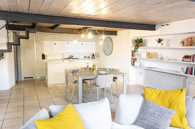 a living room with a table and a kitchen at Ottavia al Foro - Luxury Property in Rome