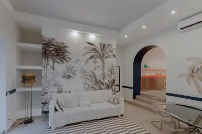 a living room with a white couch and a wall mural at Navona Harmony Apartments in Rome