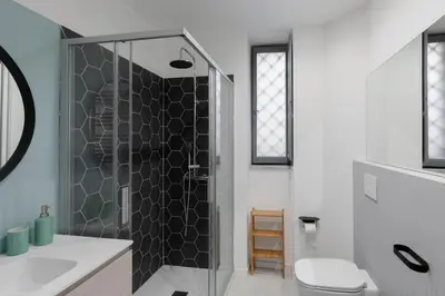 a bathroom with a shower with a toilet and a sink at Navona Harmony Apartments in Rome