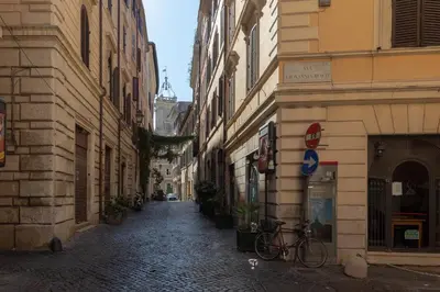 an alley with buildings and a bike parked on a street at Navona Harmony Apartments in Rome