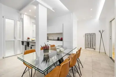 a dining room with a glass table and chairs at Vatican Dome View Apartment in Rome
