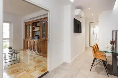 a dining room with a glass table and chairs at Vatican Dome View Apartment in Rome